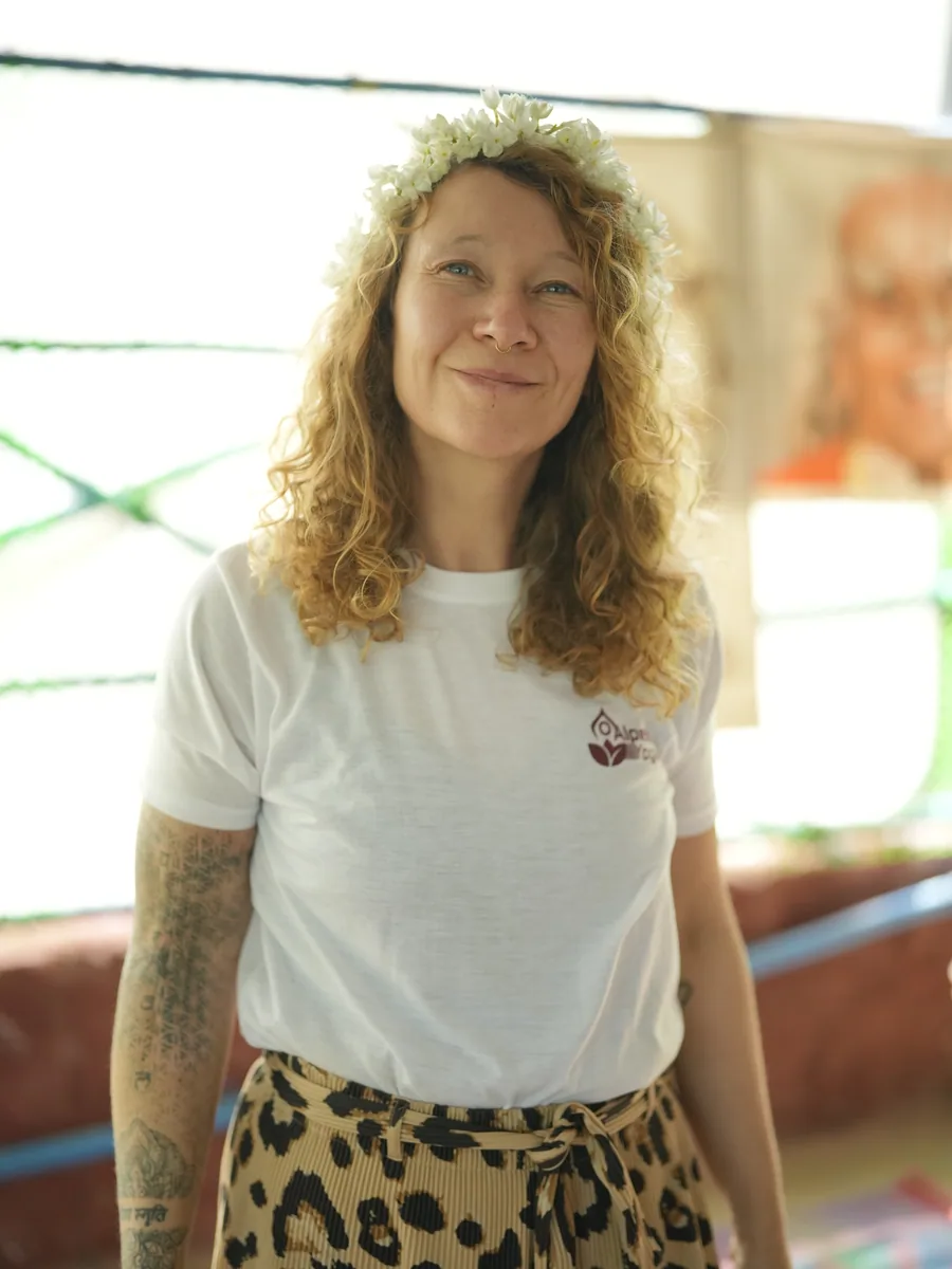 Portrait of an Alpesh Yoga graduate wearing a jasmine flower crown in the Arambol shala
