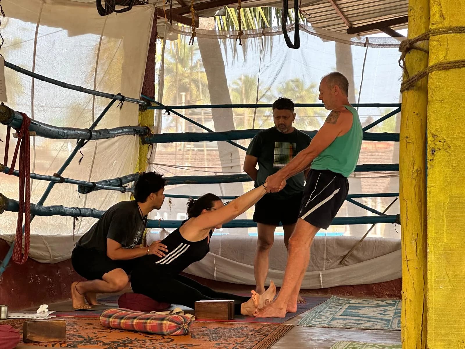 Trainees practising a partner-assisted stretch on each other during teaching practicum