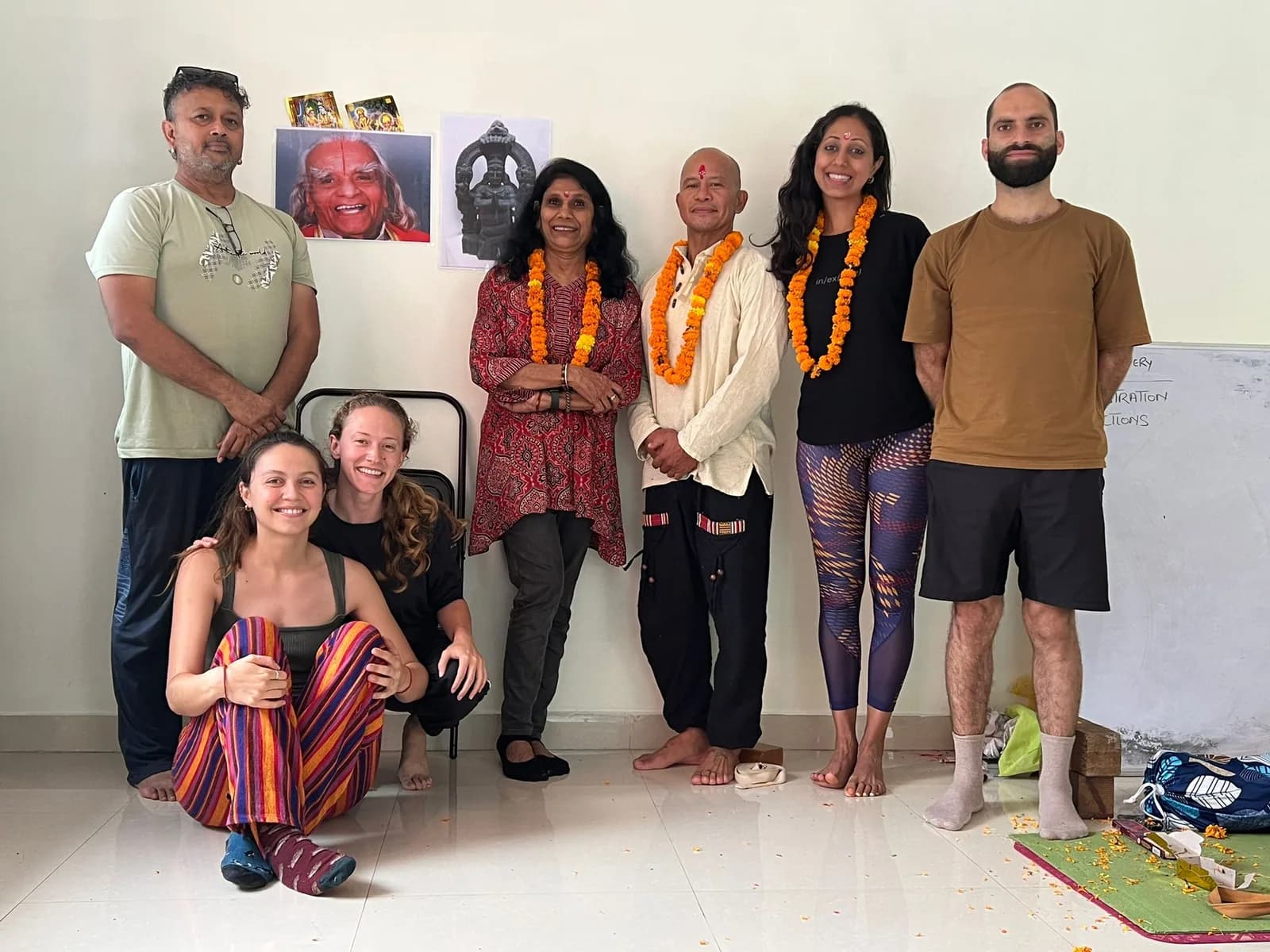 Alpesh Yoga students with visiting teachers wearing marigold garlands after a philosophy session